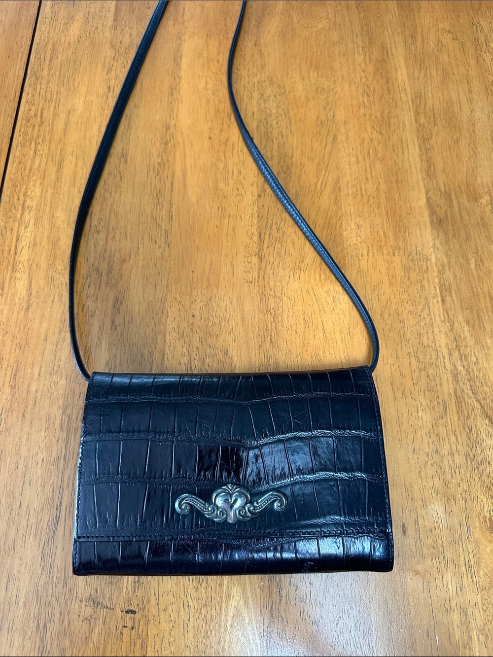 Brighton vintage black crossbody wallet with long strap.